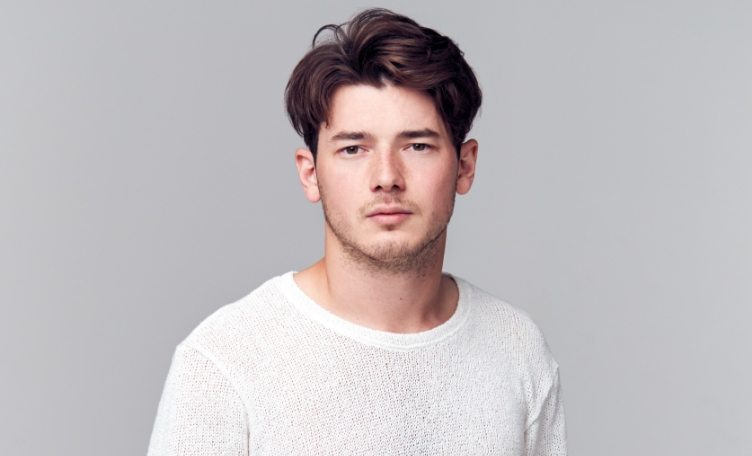 studio-portrait-of-young-man-with-serious-8YSPPQM-min